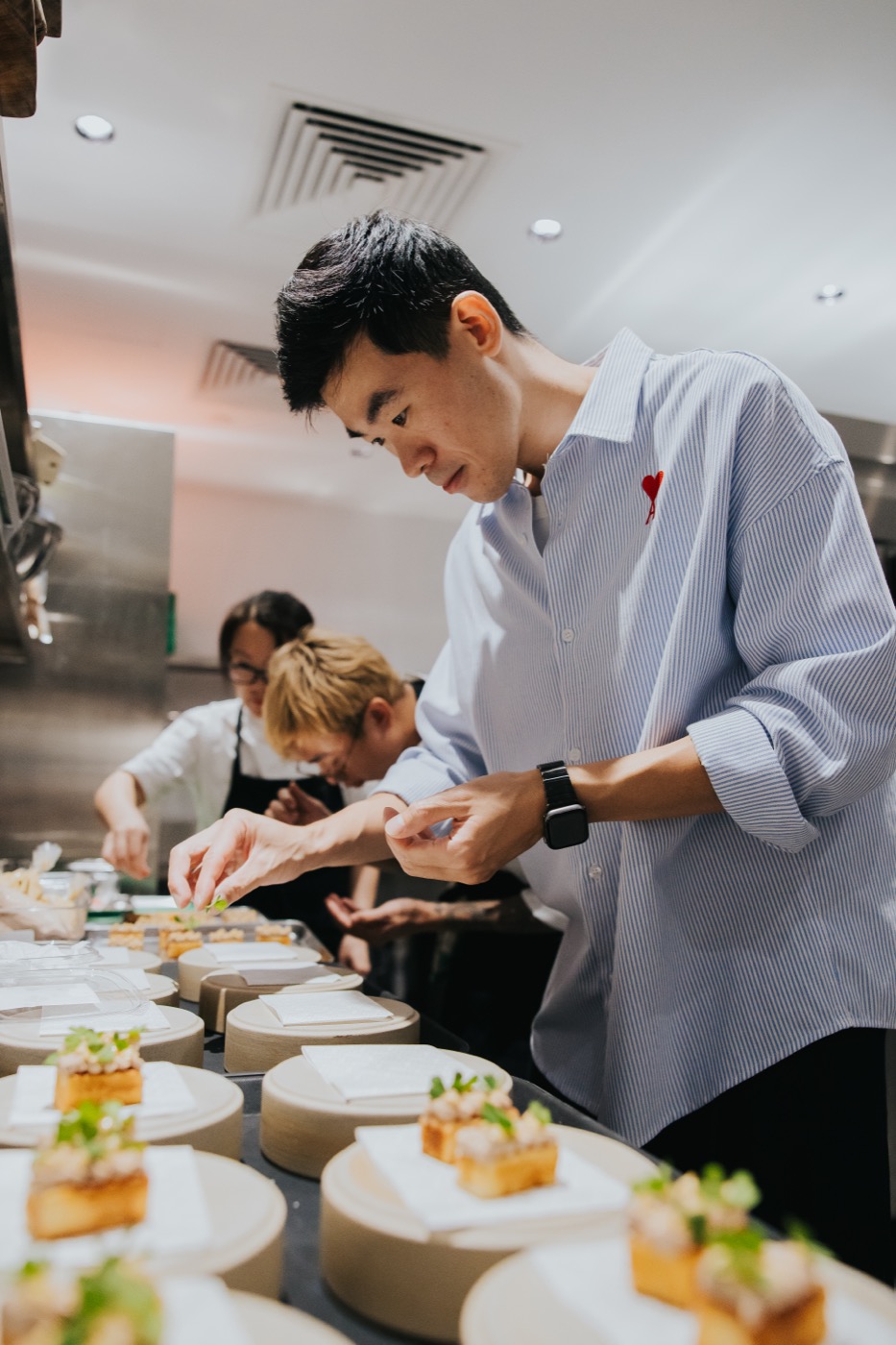 Stefan Kam plating with the kitchen team at 67 Pall Mall Singapore
